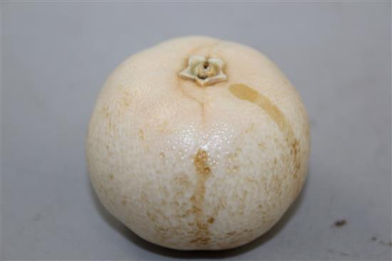 A Japanese ivory model of a partially peeled satsuma, early 20th century, 6.5cm, colour faded, age cracks